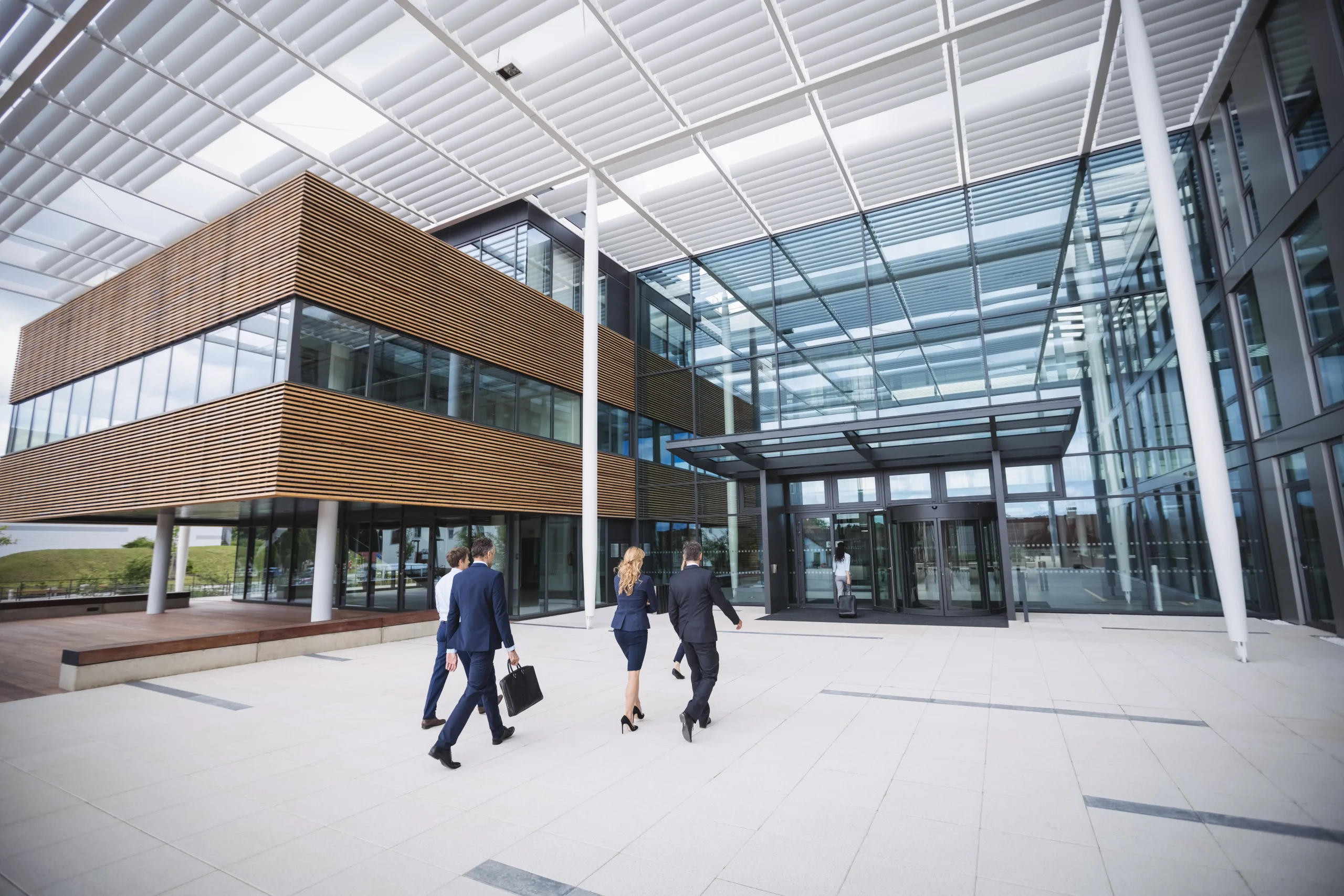 business people entering office building