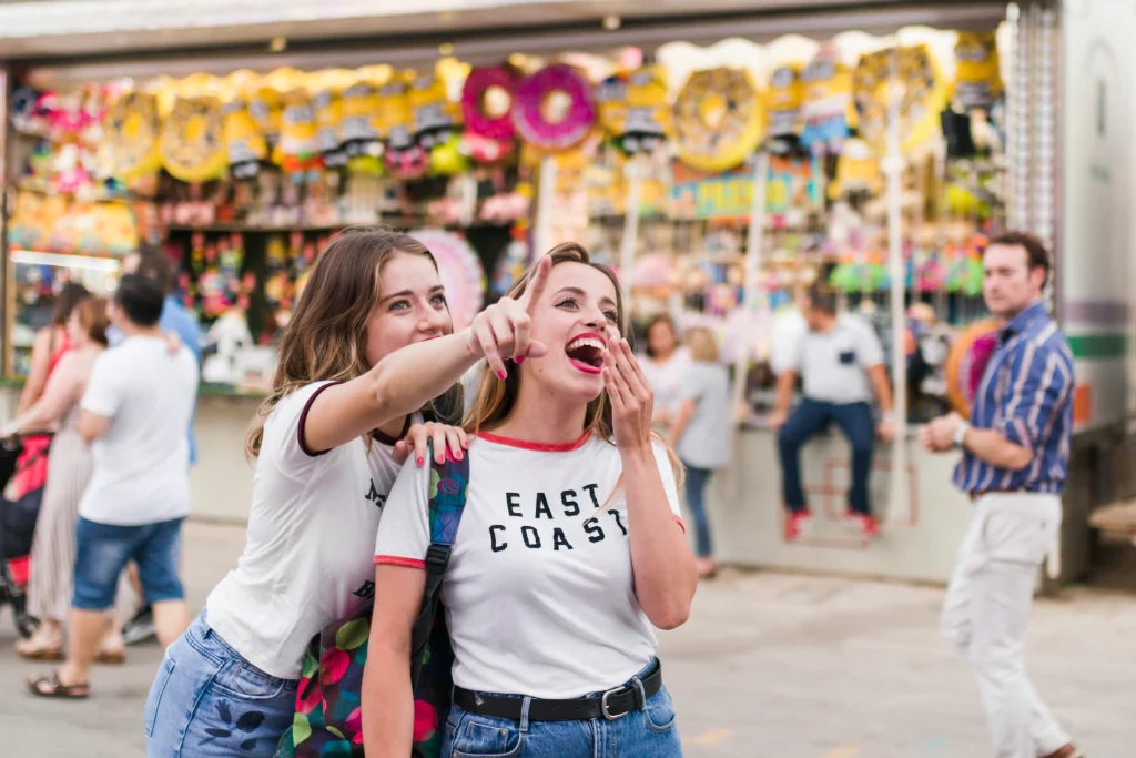 happy young friends amusement park
