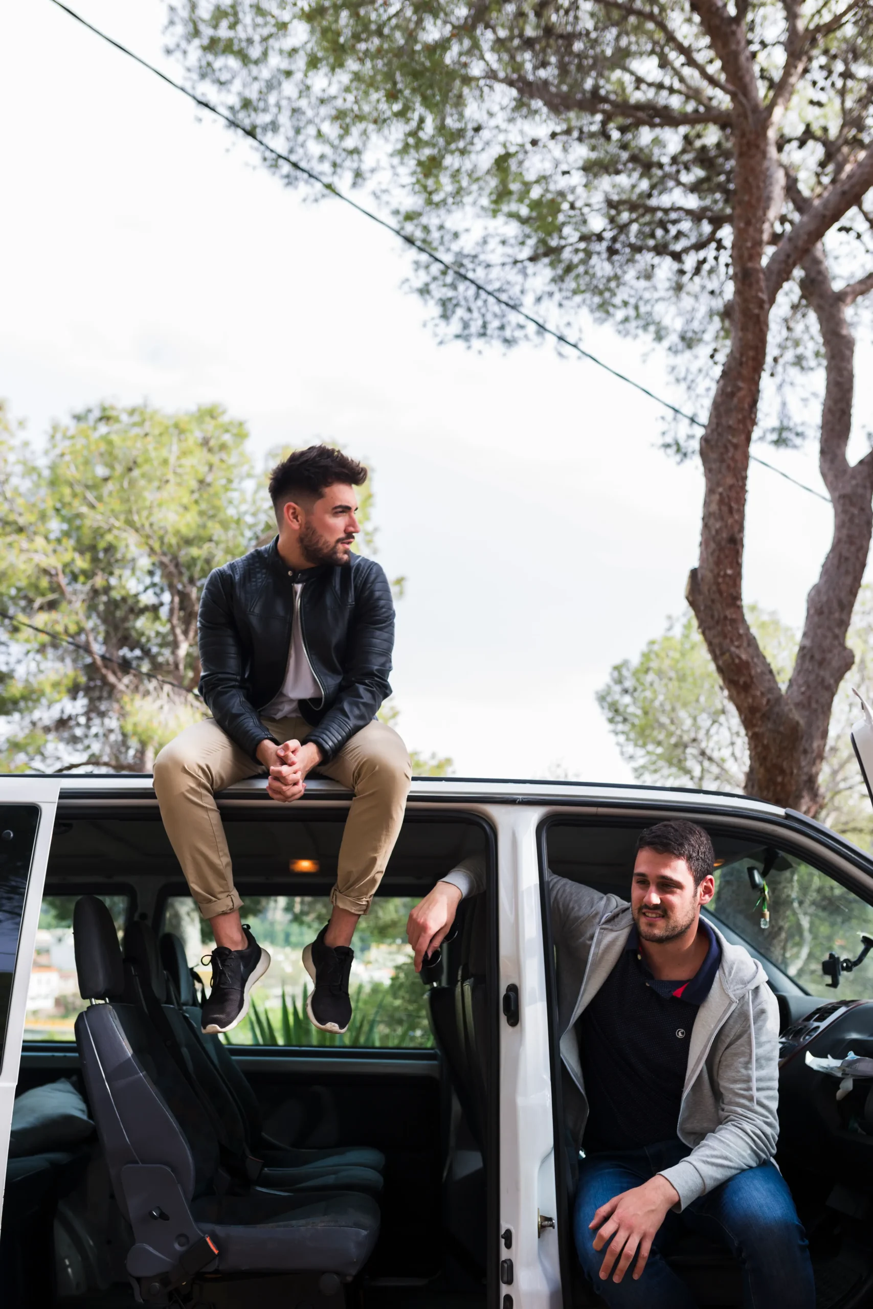 man sitting car roof