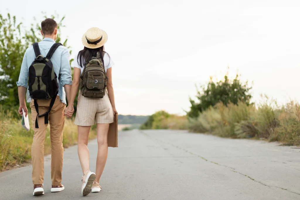 back view young couple walking down road back view young couple walking down road