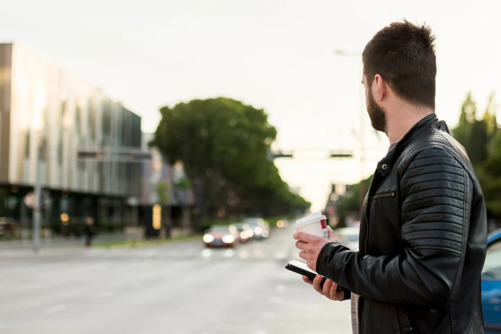 man with smartphone coffee crossing street man with smartphone coffee crossing street