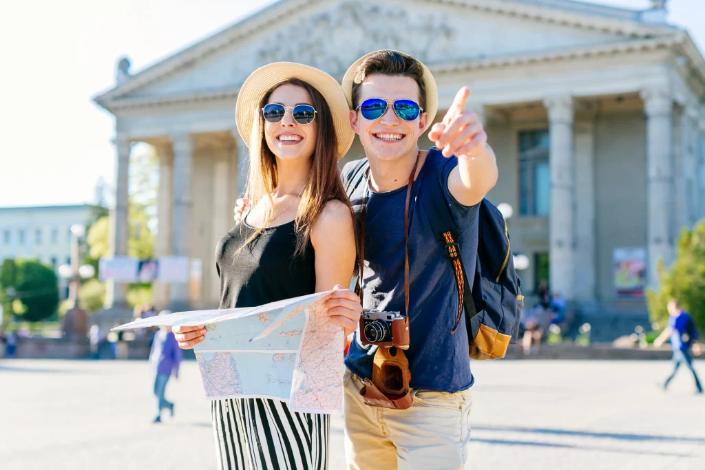 smiling tourist couple sightseeing city