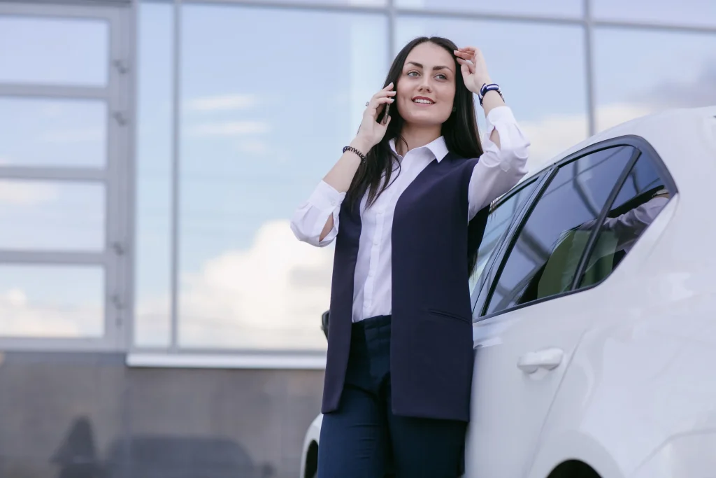 smiling woman talking phone leaning car smiling woman talking phone leaning car