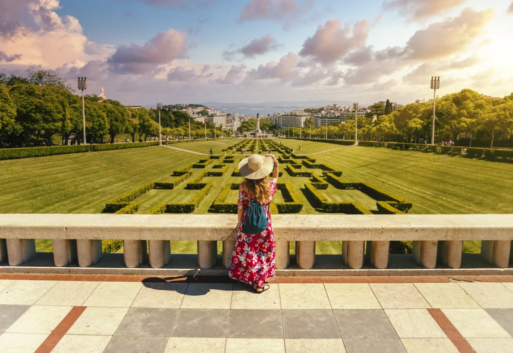 young female tourist red floral dress eduardo vii park sunlight portugal young female tourist red floral dress eduardo vii park sunlight portugal