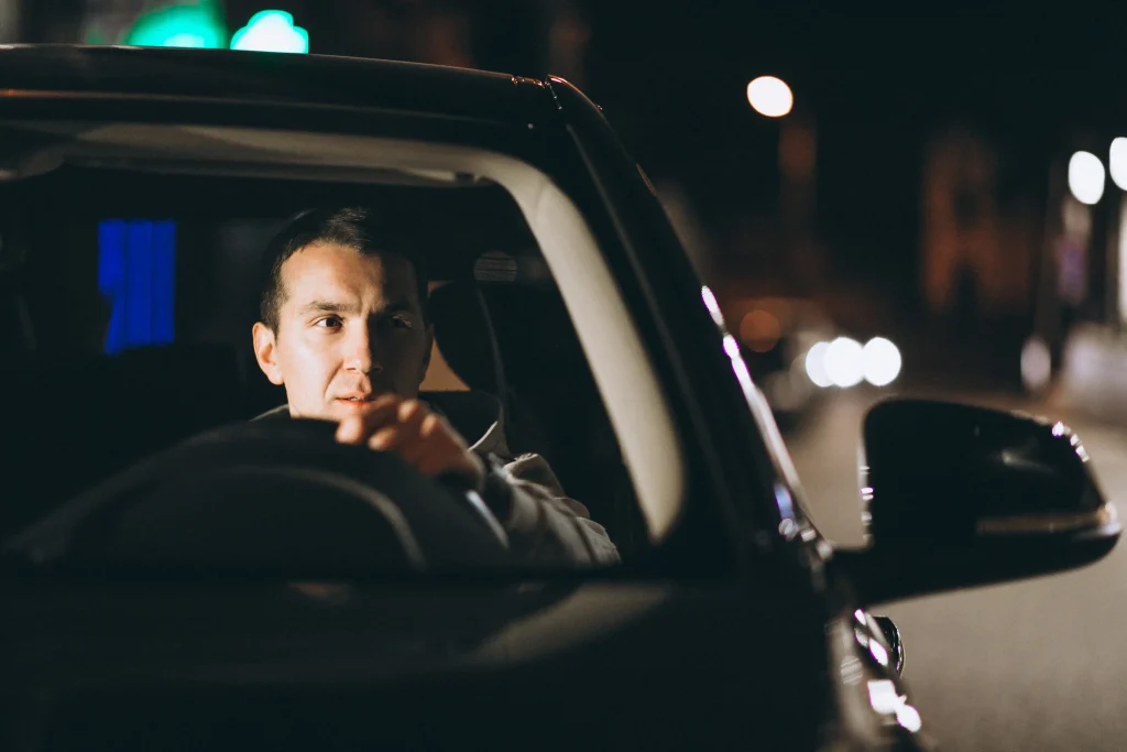 young man driving his car night time